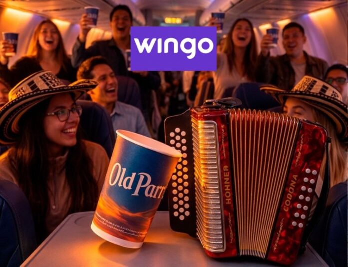 Pasajeros con sombreros vueltiaos y acordeón celebrando a bordo de un vuelo temático hacia el Festival de la Leyenda Vallenata con vuelos Wingo y Old Parr.