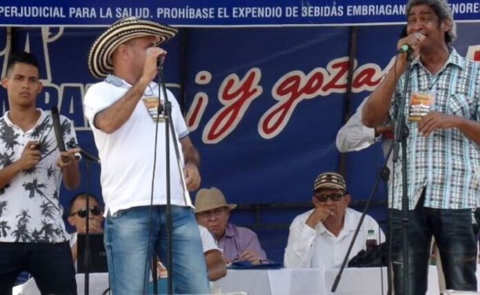 Dos verseadores compitiendo en el concurso piqueria festival vallenato 2026 sobre una tarima en Valledupar.
